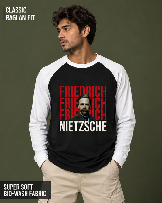 A man wearing a black and white raglan long-sleeve t-shirt with a graphic print of Friedrich Nietzsche's name in red and white, set against a dark olive green background with promotional text overlays.